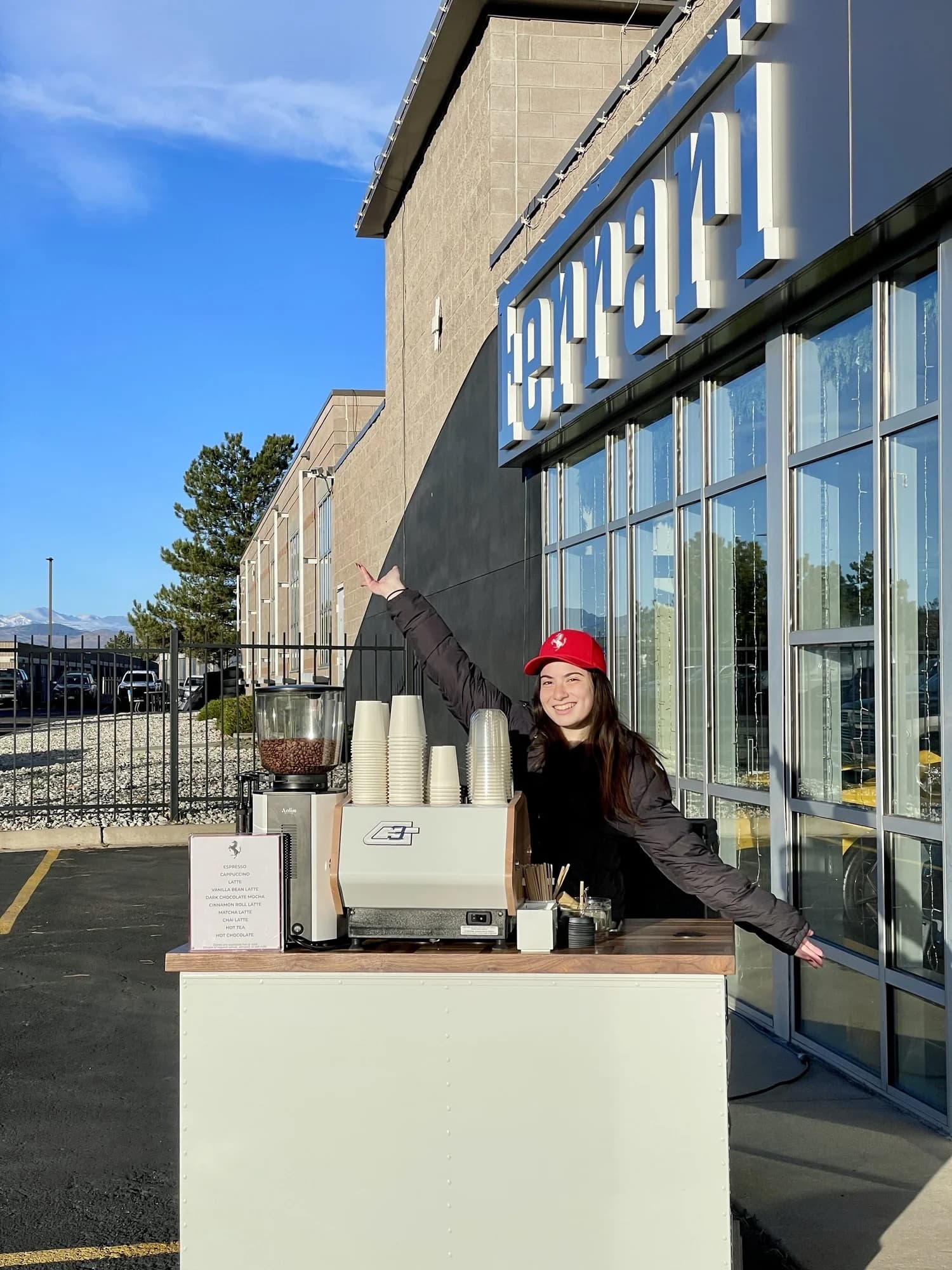 Flipside barista at a white coffee cart outside Ferrari of Denver