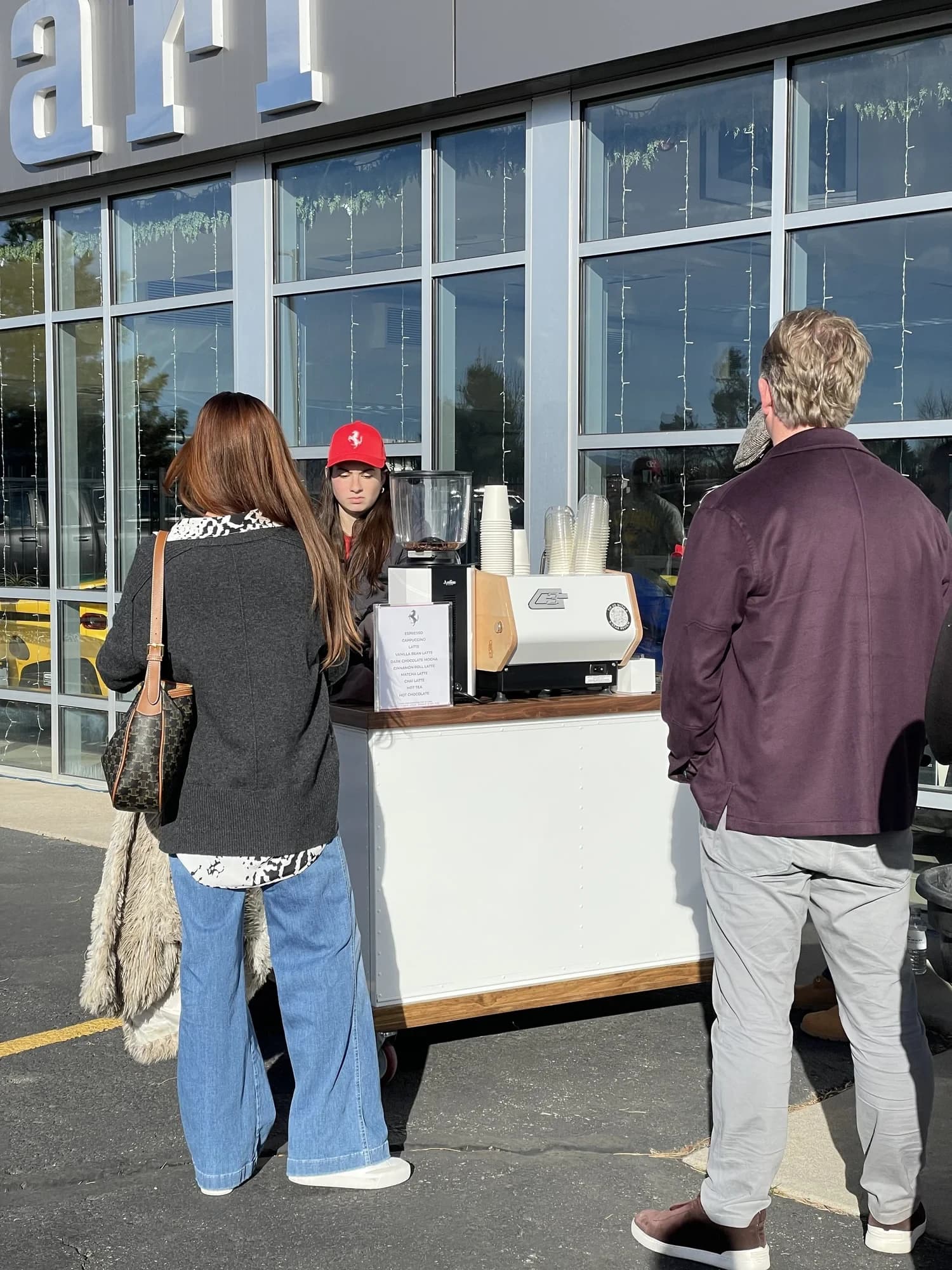 Guests lined up at a Flipside coffee cart outside Ferrari of Denver