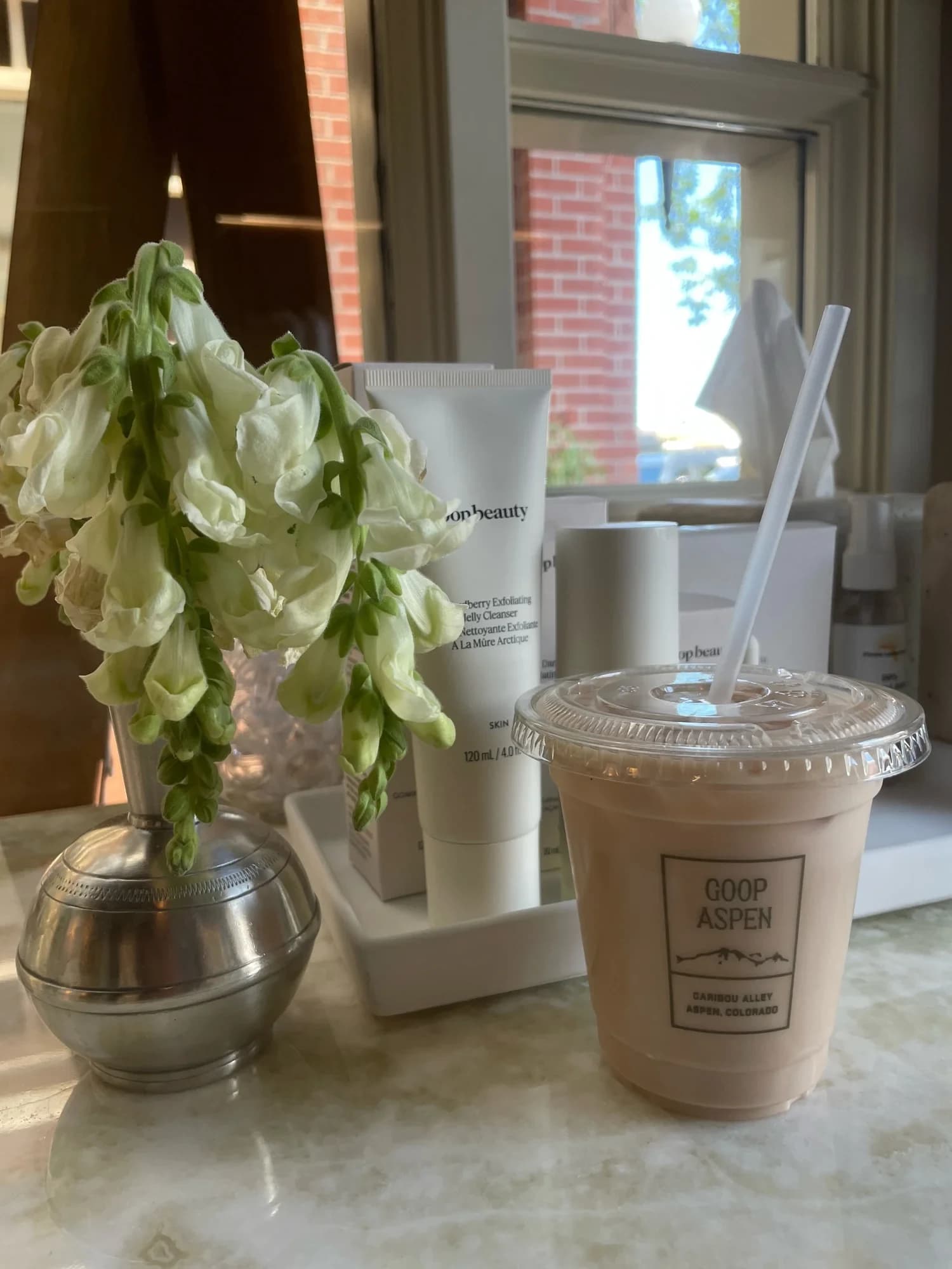 Iced latte with a GOOP ASPEN label at a brand activation
