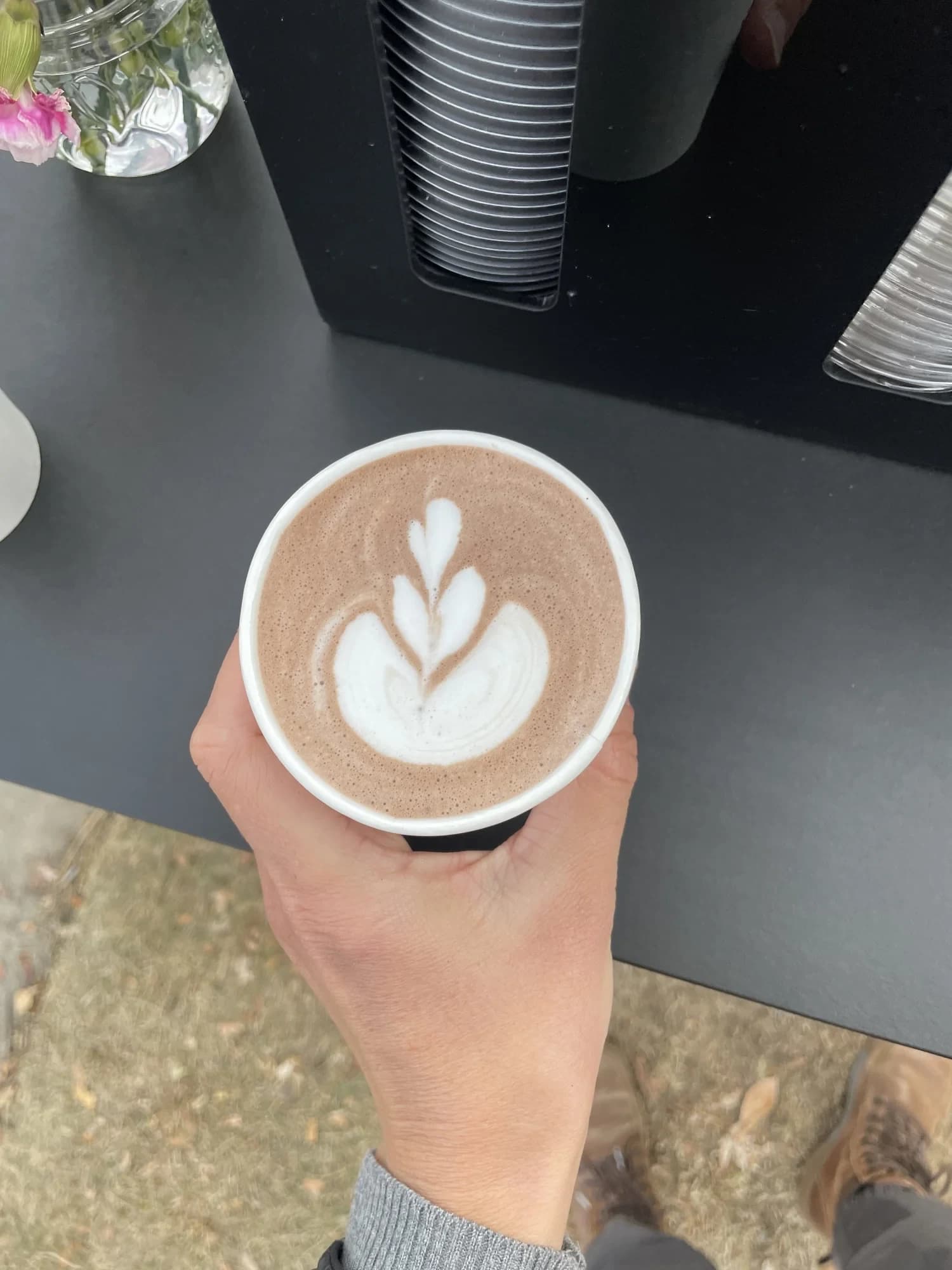 Hot chocolate with latte art held over a Flipside cart